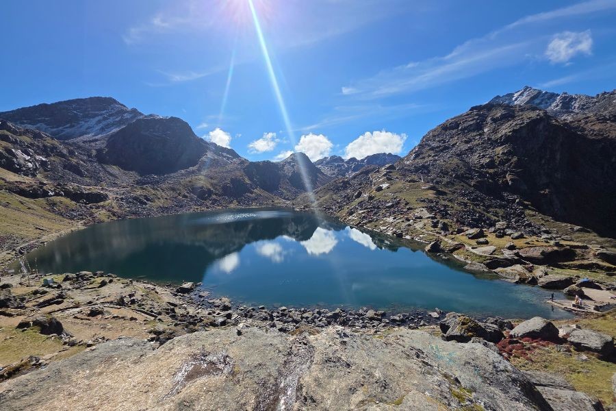 Gosaikunda Lake reflecting sky and surrounding Himalayan mountains